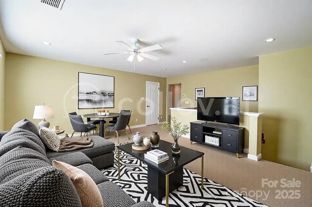 carpeted living room featuring ceiling fan, recessed lighting, visible vents, and baseboards