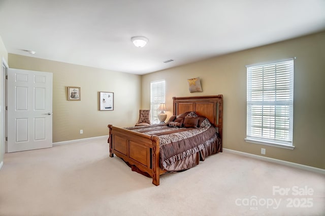 carpeted bedroom with visible vents and baseboards