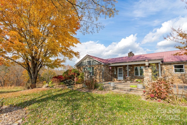 back of house featuring a yard and a patio