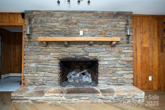 room details with wood walls and a fireplace