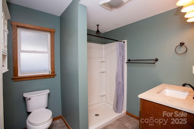 bathroom featuring tile patterned floors, a shower with curtain, vanity, and toilet