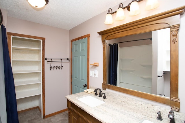 bathroom featuring vanity and a textured ceiling