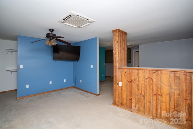 unfurnished living room featuring ceiling fan and light colored carpet