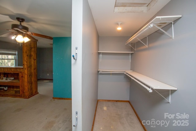 walk in closet featuring ceiling fan