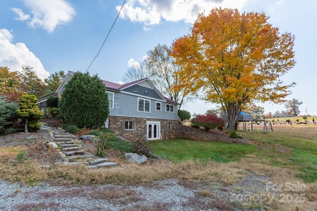 view of side of home featuring a yard