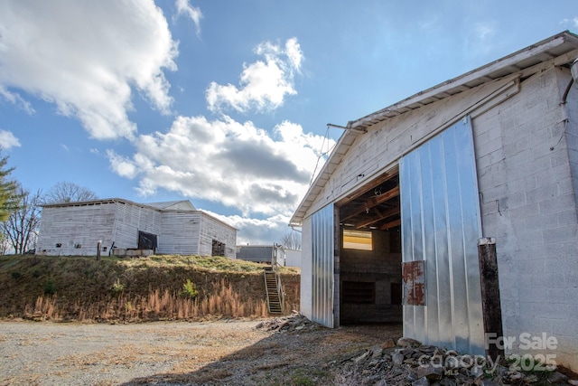 view of side of property with an outbuilding