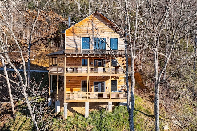 back of property featuring a balcony