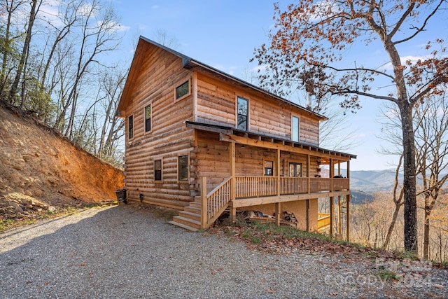 view of front of home with covered porch and a mountain view