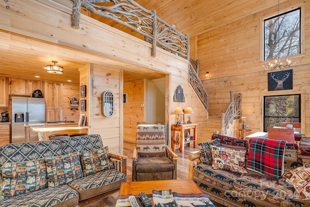 living room featuring hardwood / wood-style floors, an inviting chandelier, and wood walls