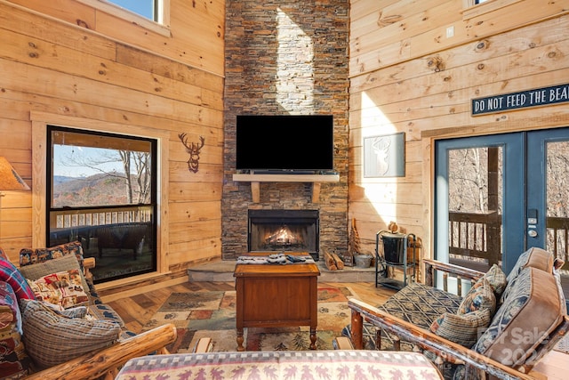 living room with a wealth of natural light, a fireplace, and wood-type flooring