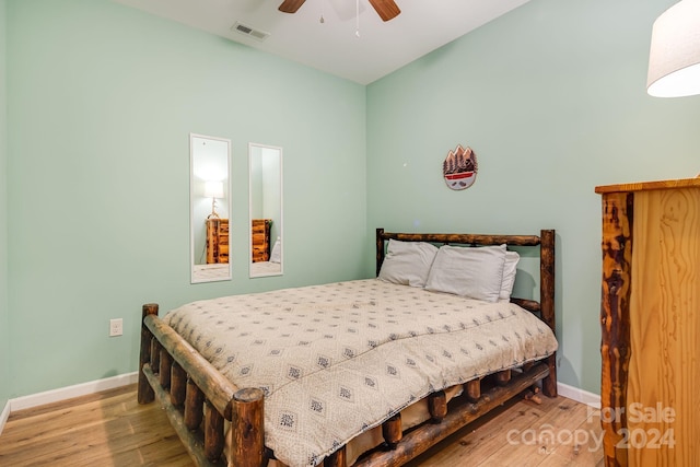 bedroom with ceiling fan and hardwood / wood-style flooring