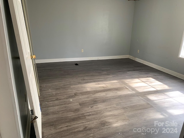 empty room featuring dark hardwood / wood-style flooring