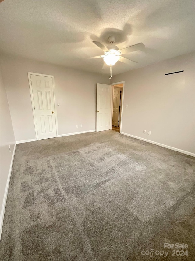 spare room with ceiling fan, carpet floors, and a textured ceiling