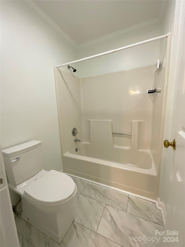 bathroom featuring bathtub / shower combination and toilet