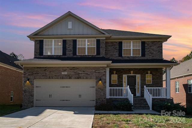 craftsman-style house featuring covered porch and a garage