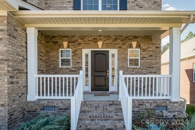 entrance to property featuring covered porch