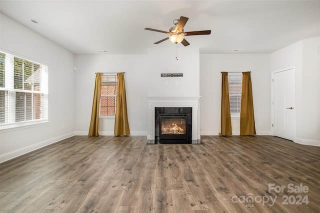 unfurnished living room with ceiling fan and dark hardwood / wood-style flooring