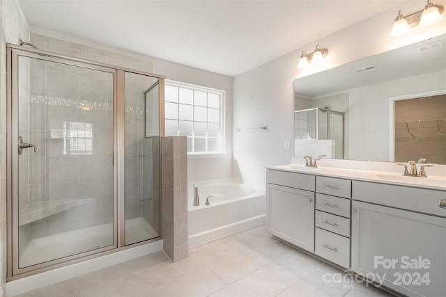 bathroom with tile patterned flooring, vanity, and separate shower and tub