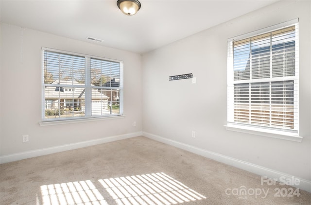 empty room featuring light carpet