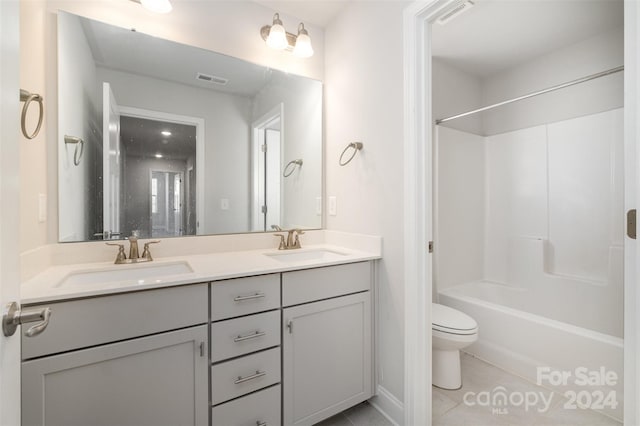 full bathroom with tile patterned floors, vanity,  shower combination, and toilet