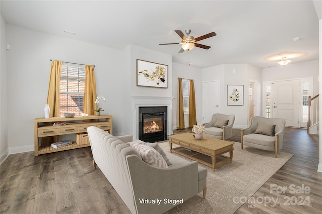 living room with ceiling fan and dark hardwood / wood-style floors