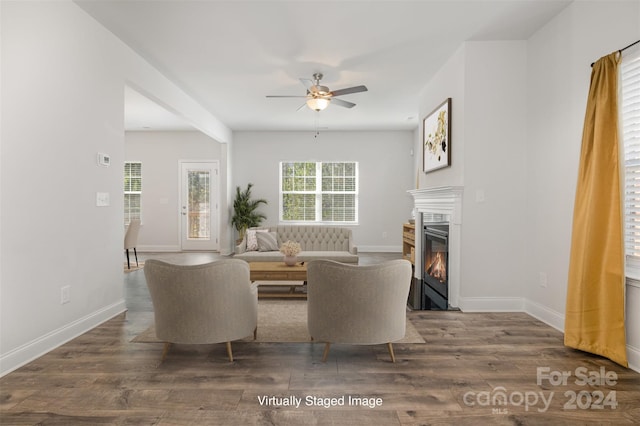 living room with ceiling fan and dark hardwood / wood-style flooring