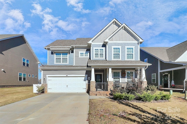 craftsman-style house with a garage, covered porch, and a front lawn