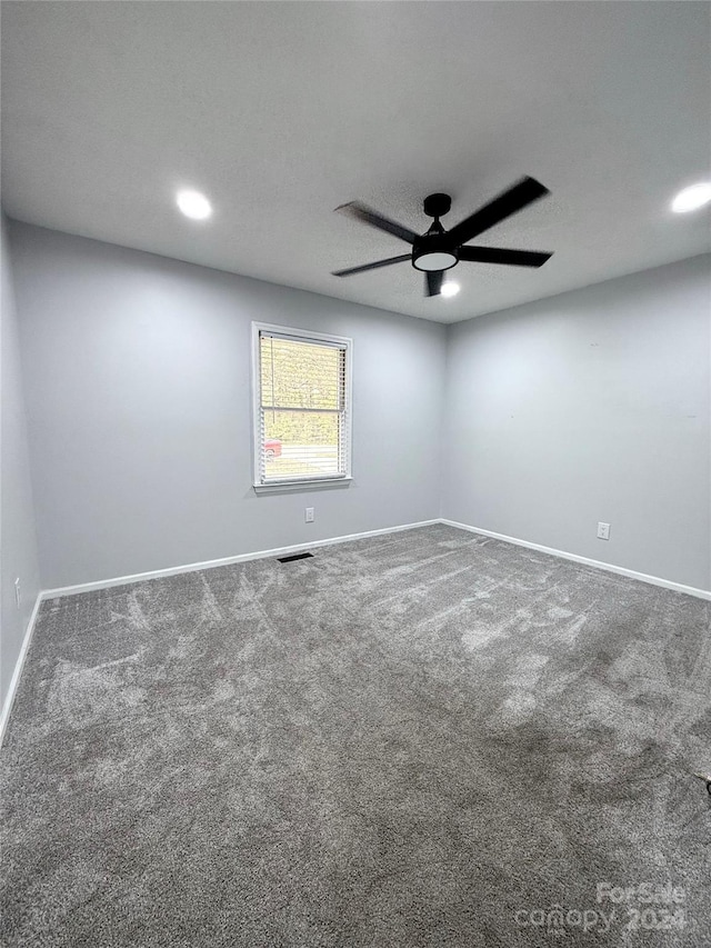 spare room with carpet and ceiling fan