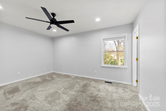 spare room featuring recessed lighting, light colored carpet, visible vents, and baseboards