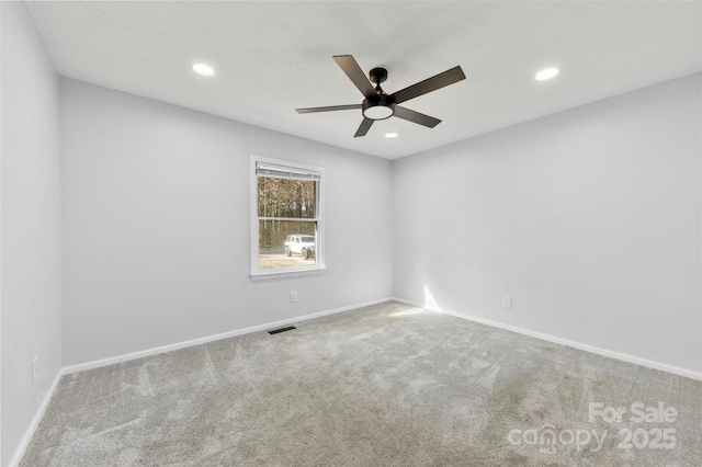 unfurnished room featuring carpet, visible vents, baseboards, and recessed lighting