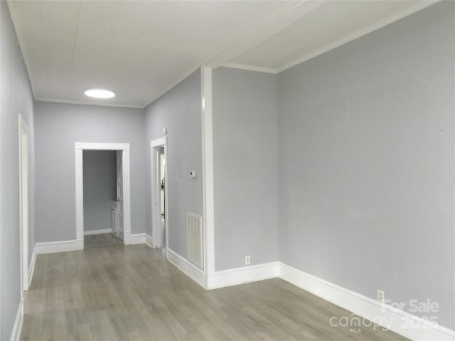 interior space with hardwood / wood-style flooring and crown molding