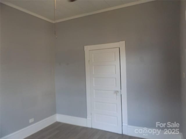 spare room with hardwood / wood-style floors and ornamental molding