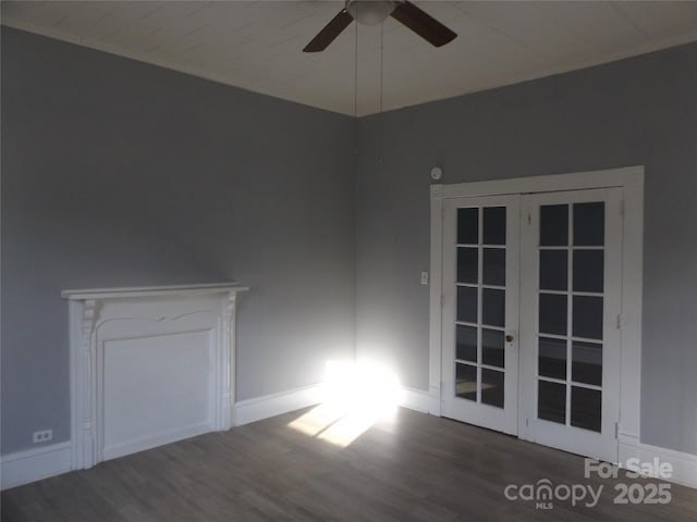 unfurnished room with ceiling fan, dark wood-type flooring, and french doors