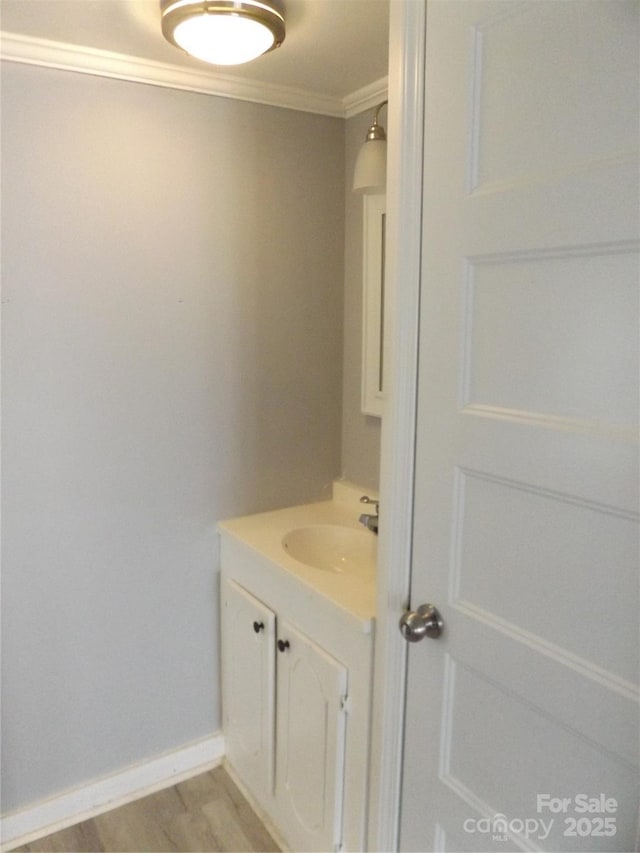 bathroom featuring vanity and ornamental molding