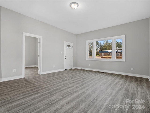 unfurnished living room featuring wood-type flooring