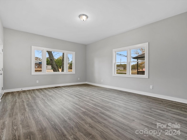 empty room featuring dark hardwood / wood-style floors and a healthy amount of sunlight