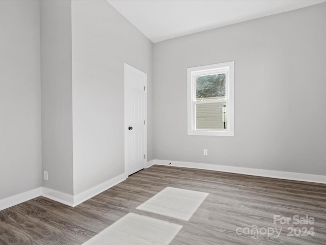 spare room featuring wood-type flooring