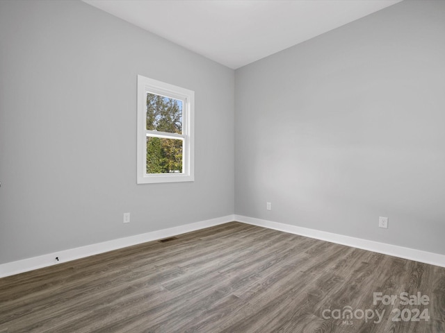 empty room with dark hardwood / wood-style floors