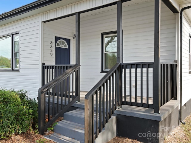 view of exterior entry featuring a porch