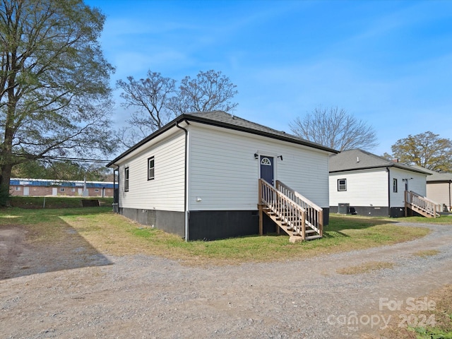 rear view of property featuring central AC