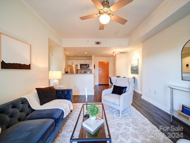 living room featuring ceiling fan, dark hardwood / wood-style floors, and ornamental molding