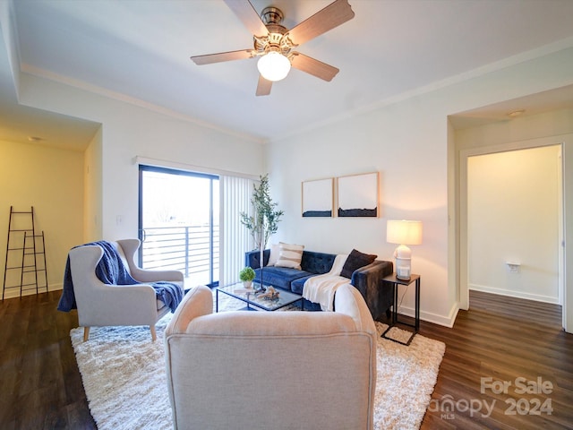 living room with ceiling fan, crown molding, and dark wood-type flooring