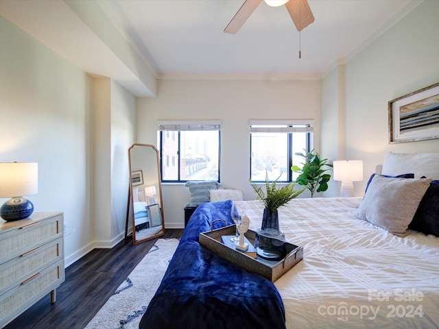 bedroom featuring ceiling fan, crown molding, and dark wood-type flooring