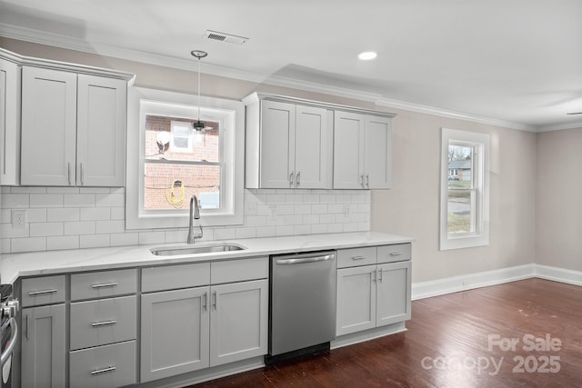 kitchen featuring stainless steel appliances, gray cabinetry, decorative backsplash, decorative light fixtures, and sink