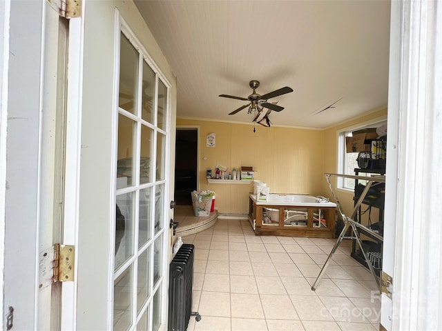 interior space featuring ceiling fan and radiator heating unit