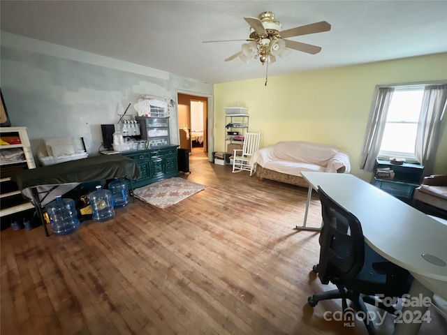 home office with ceiling fan and light hardwood / wood-style floors