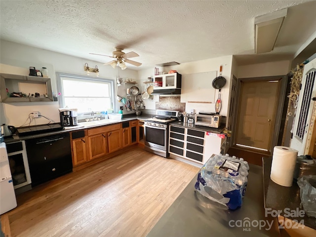 kitchen with a textured ceiling, ceiling fan, light hardwood / wood-style flooring, stainless steel range oven, and dishwasher