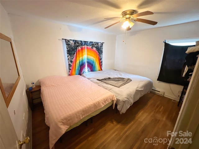 bedroom featuring ceiling fan, a baseboard radiator, and dark hardwood / wood-style floors