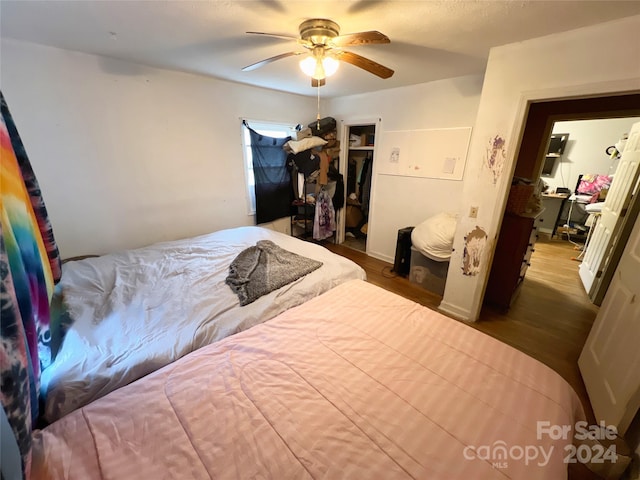 bedroom featuring a closet, ceiling fan, and dark wood-type flooring