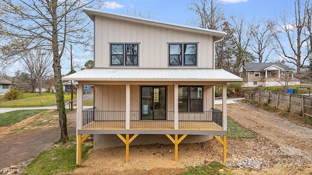 back of property featuring covered porch